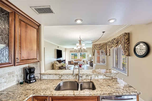 kitchen featuring sink, light stone counters, an inviting chandelier, dishwasher, and decorative backsplash