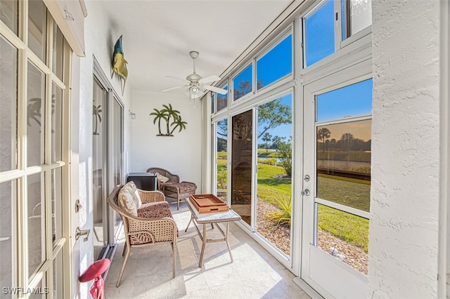 sunroom / solarium featuring ceiling fan