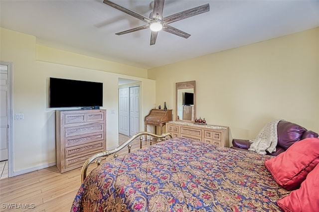 bedroom with a closet, ceiling fan, and light hardwood / wood-style flooring