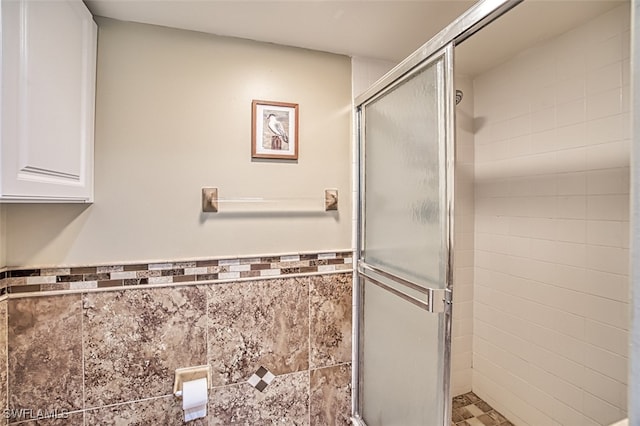 bathroom with walk in shower and tile walls