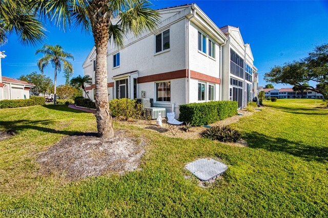 view of side of property with a lawn