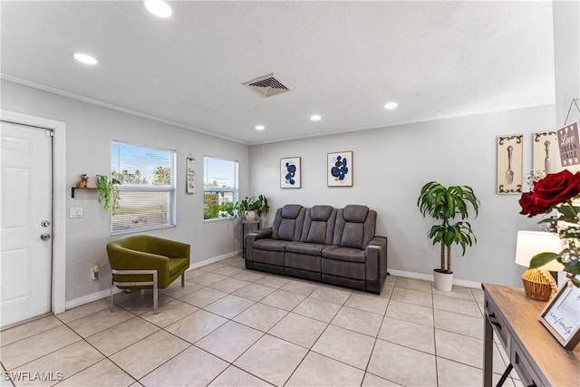 living room with light tile patterned floors, crown molding, and a textured ceiling