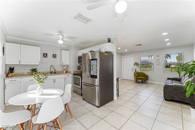 kitchen featuring sink, ceiling fan, appliances with stainless steel finishes, white cabinets, and light tile patterned flooring