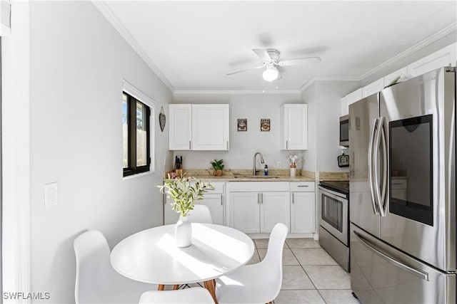 kitchen with light tile patterned flooring, sink, white cabinetry, ornamental molding, and appliances with stainless steel finishes