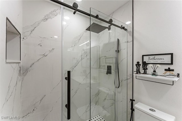 bathroom featuring an enclosed shower and toilet