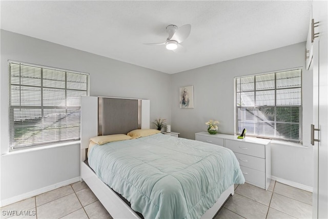 tiled bedroom featuring ceiling fan