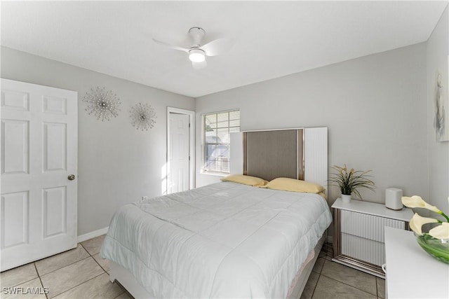 bedroom with light tile patterned flooring, ceiling fan, and radiator heating unit