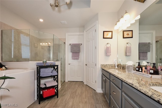 bathroom featuring vanity, hardwood / wood-style flooring, and a shower with shower door