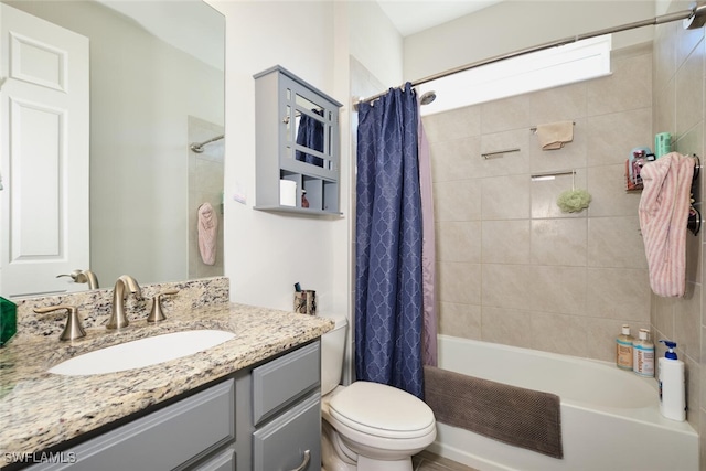 full bathroom featuring shower / bathtub combination with curtain, vanity, and toilet