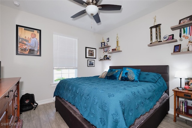 bedroom with ceiling fan and light wood-type flooring