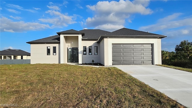 prairie-style home with a garage and a front lawn