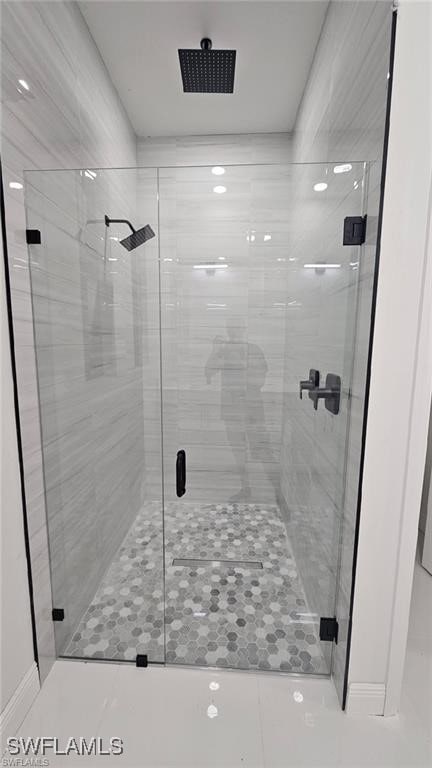 bathroom with a shower with door