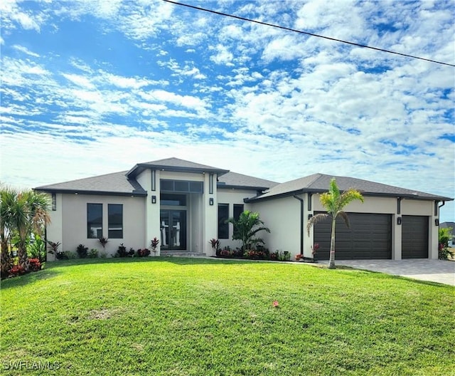 view of front of home featuring a garage and a front yard