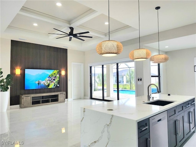 kitchen with sink, coffered ceiling, stainless steel dishwasher, light stone counters, and a center island with sink