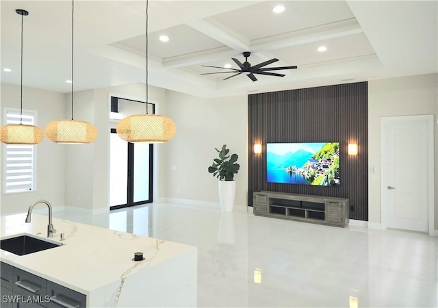 living room featuring beamed ceiling, coffered ceiling, sink, and a healthy amount of sunlight