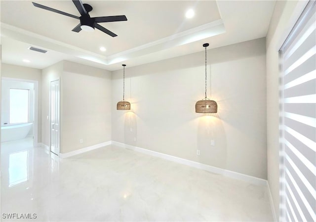 spare room featuring a tray ceiling and ceiling fan