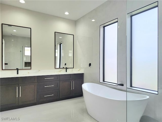 bathroom with vanity and a tub