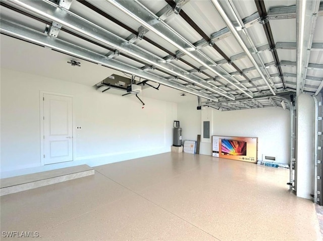 garage featuring a garage door opener, electric panel, and water heater