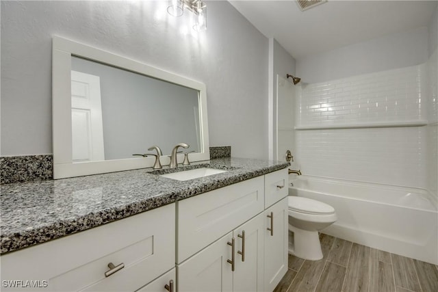 full bathroom with vanity, toilet, and tiled shower / bath combo