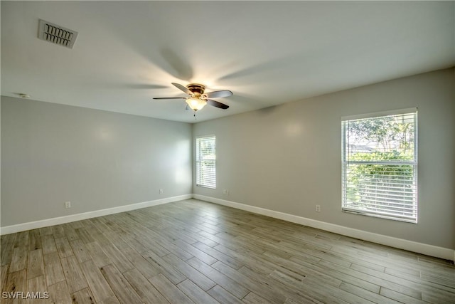 empty room featuring ceiling fan and light hardwood / wood-style flooring