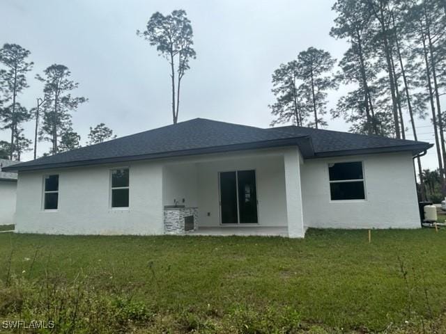 back of property featuring a yard and a patio