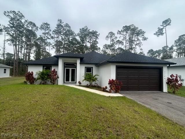 view of front of property featuring a garage and a front lawn