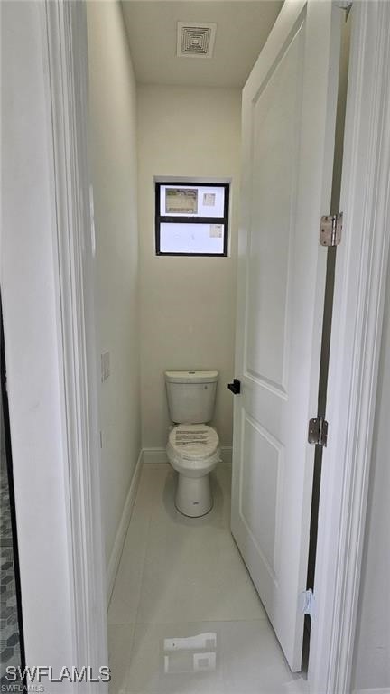 bathroom featuring tile patterned flooring and toilet