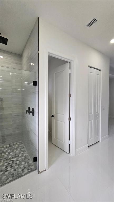 full bathroom with a stall shower, baseboards, and visible vents