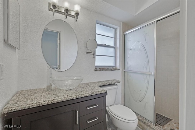 bathroom featuring vanity, toilet, and walk in shower