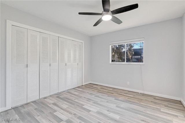 unfurnished bedroom featuring a closet, ceiling fan, and light hardwood / wood-style flooring