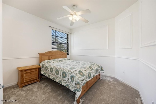 carpeted bedroom featuring baseboards and a ceiling fan