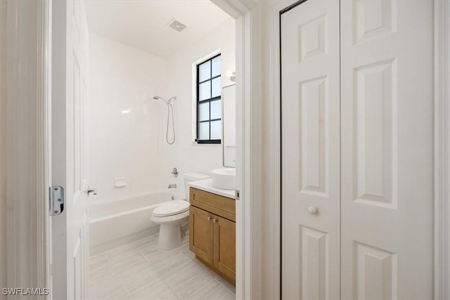 full bathroom with visible vents, bathing tub / shower combination, toilet, vanity, and a closet