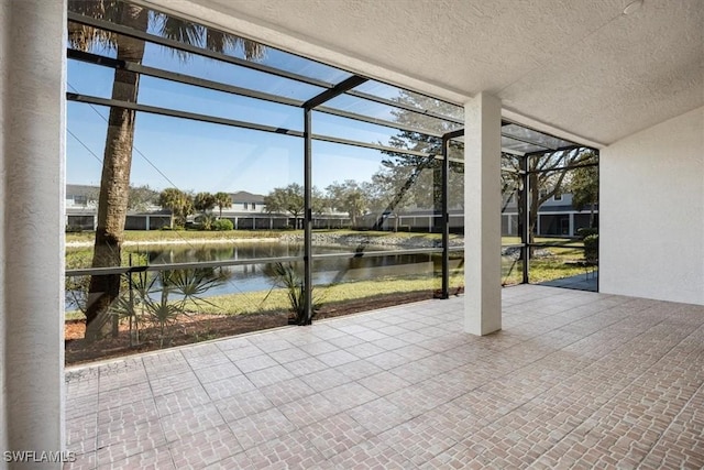 unfurnished sunroom with a water view