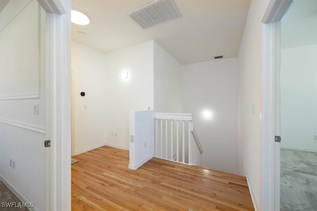 hallway with light hardwood / wood-style floors