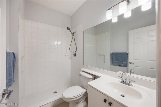 bathroom featuring a stall shower, vanity, and toilet