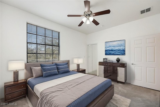 bedroom with a ceiling fan, visible vents, and light colored carpet