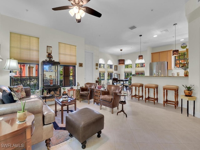 tiled living room featuring ceiling fan