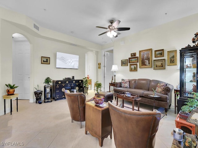 tiled living room featuring ceiling fan