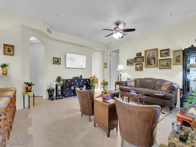 tiled living room featuring ceiling fan