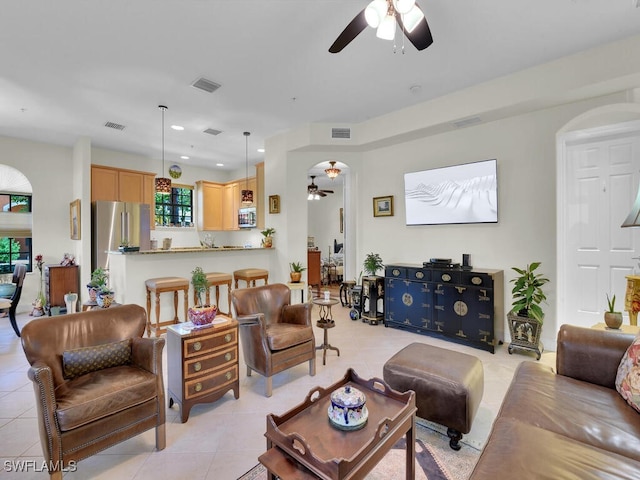 tiled living room with ceiling fan