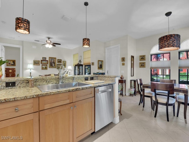 kitchen featuring pendant lighting, sink, light tile patterned floors, light brown cabinetry, and stainless steel dishwasher