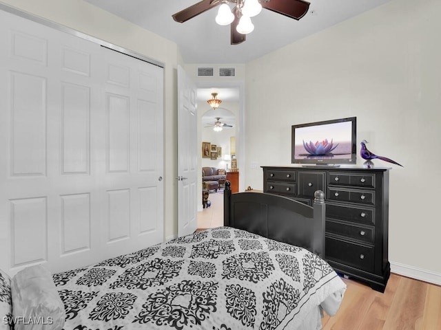 bedroom featuring ceiling fan, a closet, and light wood-type flooring