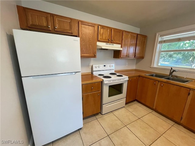 kitchen with sink, white appliances, and light tile patterned floors