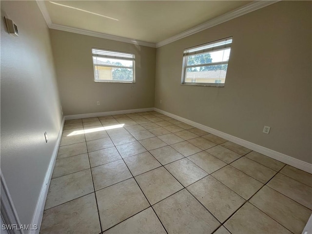 unfurnished room with crown molding, light tile patterned floors, and a wealth of natural light