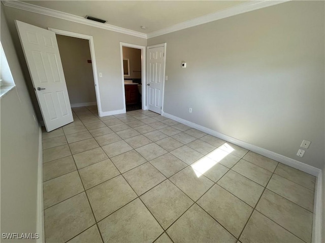 unfurnished bedroom with light tile patterned flooring and crown molding