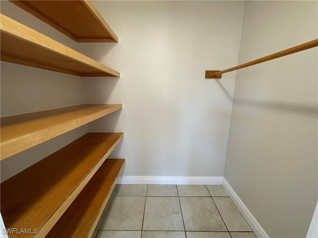 spacious closet with light tile patterned flooring