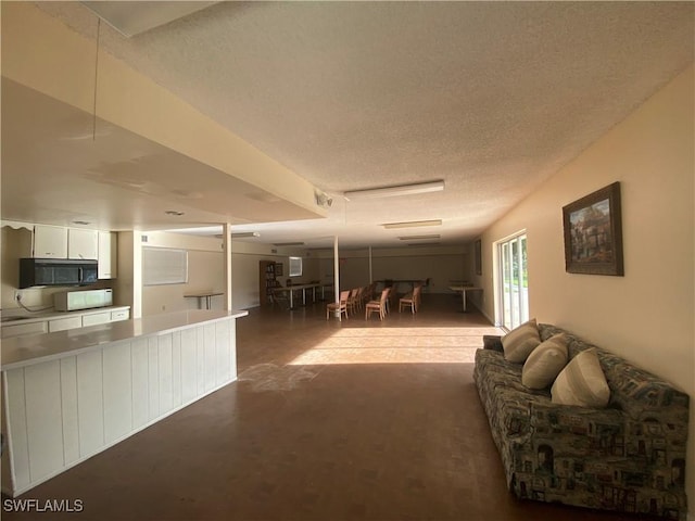 living room featuring concrete floors and a textured ceiling