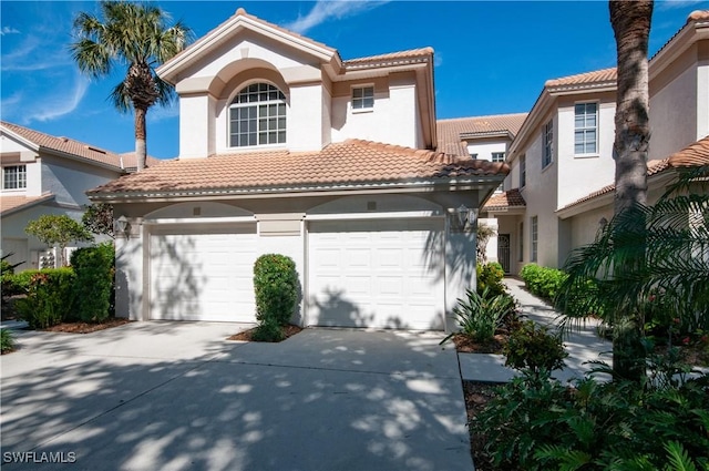 mediterranean / spanish home featuring a garage