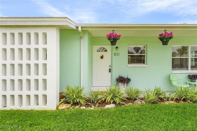 831 Lake Mcgregor Dr, Fort Myers, FL 33919 - doorway to property with stucco siding
