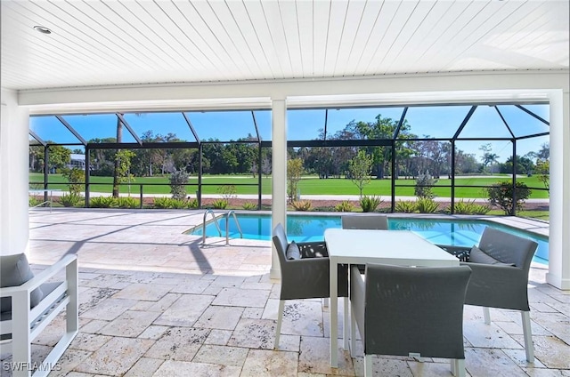 view of swimming pool featuring a lanai and a patio area